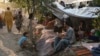 AFGHANISTAN - Internally displaced Afghan families, who fled from Kunduz, Takhar and Baghlan province due to battles between Taliban and Afghan security forces, sit in front of their temporary tents at Sara-e-Shamali in Kabul, August 11, 2021