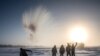 RUSSIA - A villager throws hot water into the air while harvesting ice from a local lake near the settlement of Oy, some 70 km south of Yakutsk, with the air temperature at about minus 41 degrees Celsius, on November 27, 2018